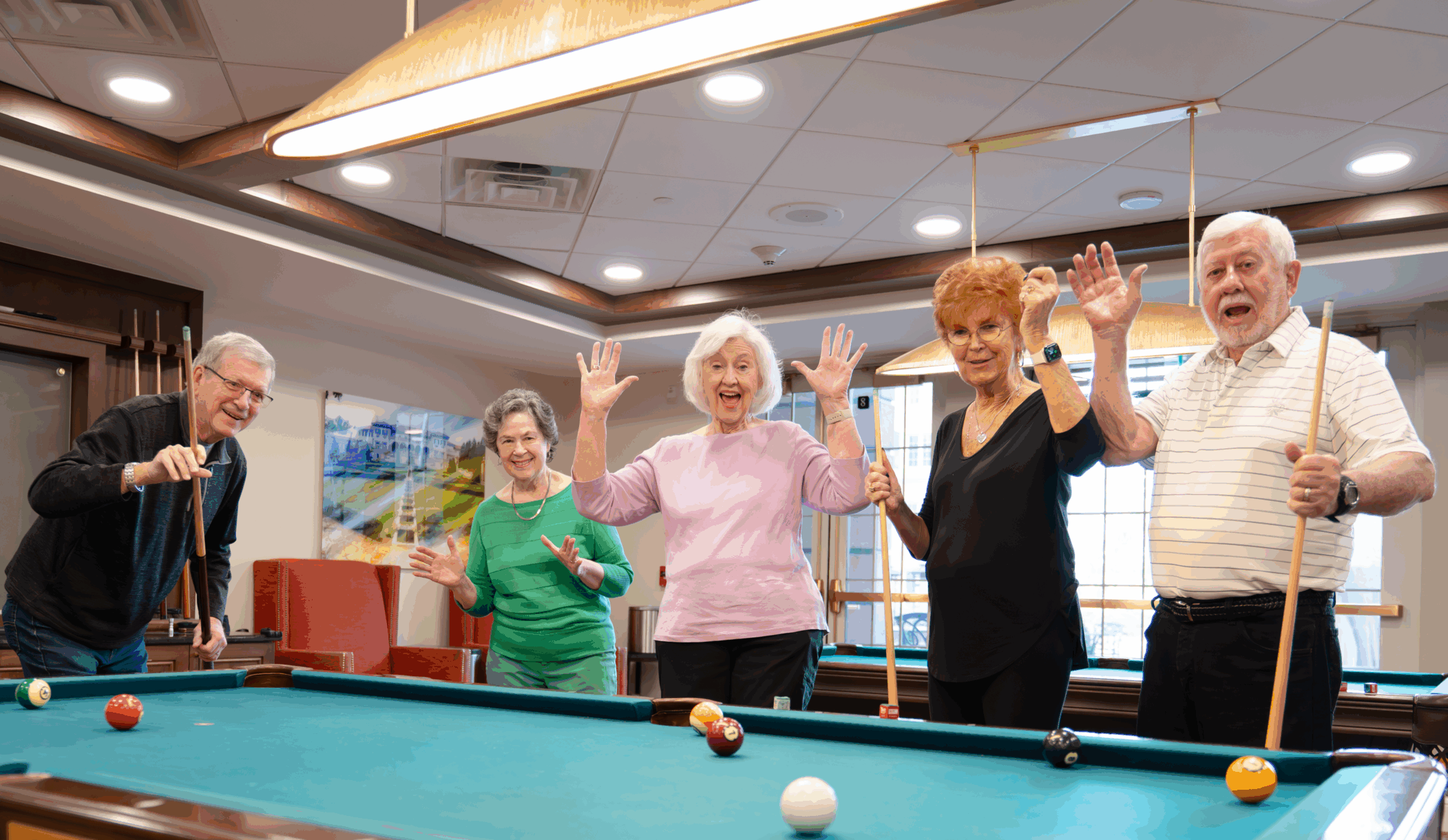 Seniors playing billiards celebrating