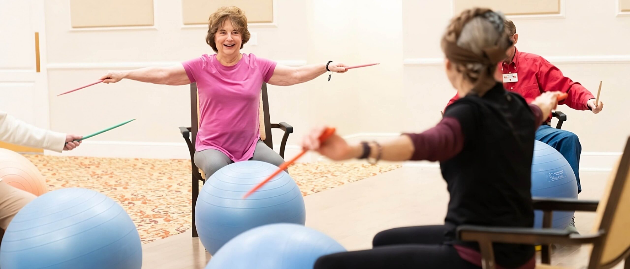 Wide shots of residents participating in a Drum Cardio class