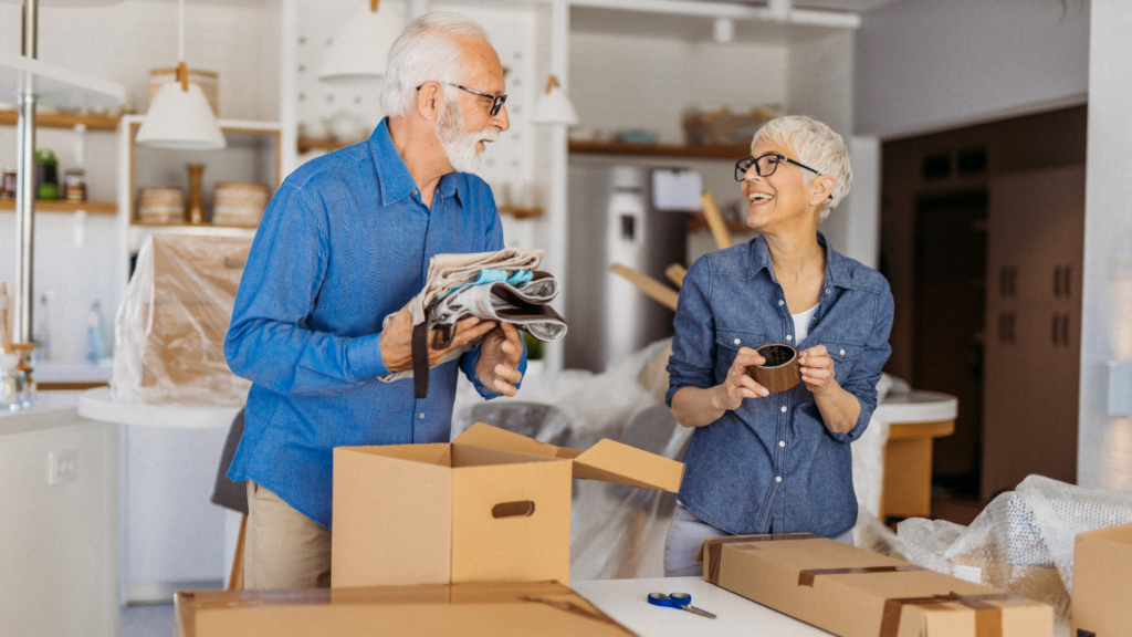 Senior couple packing moving boxes