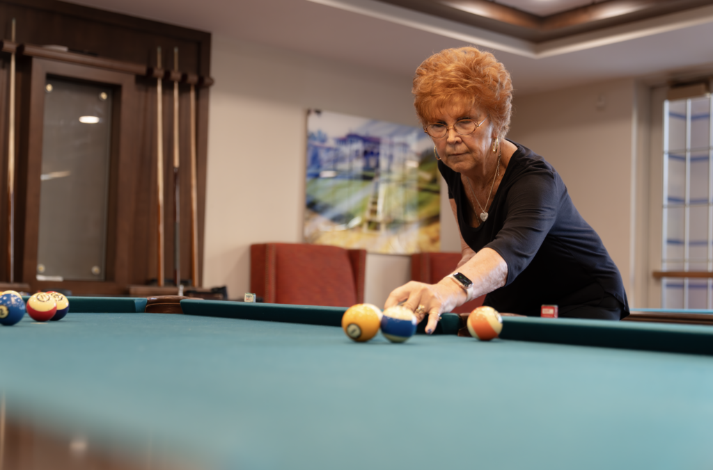 Woman playing billiards