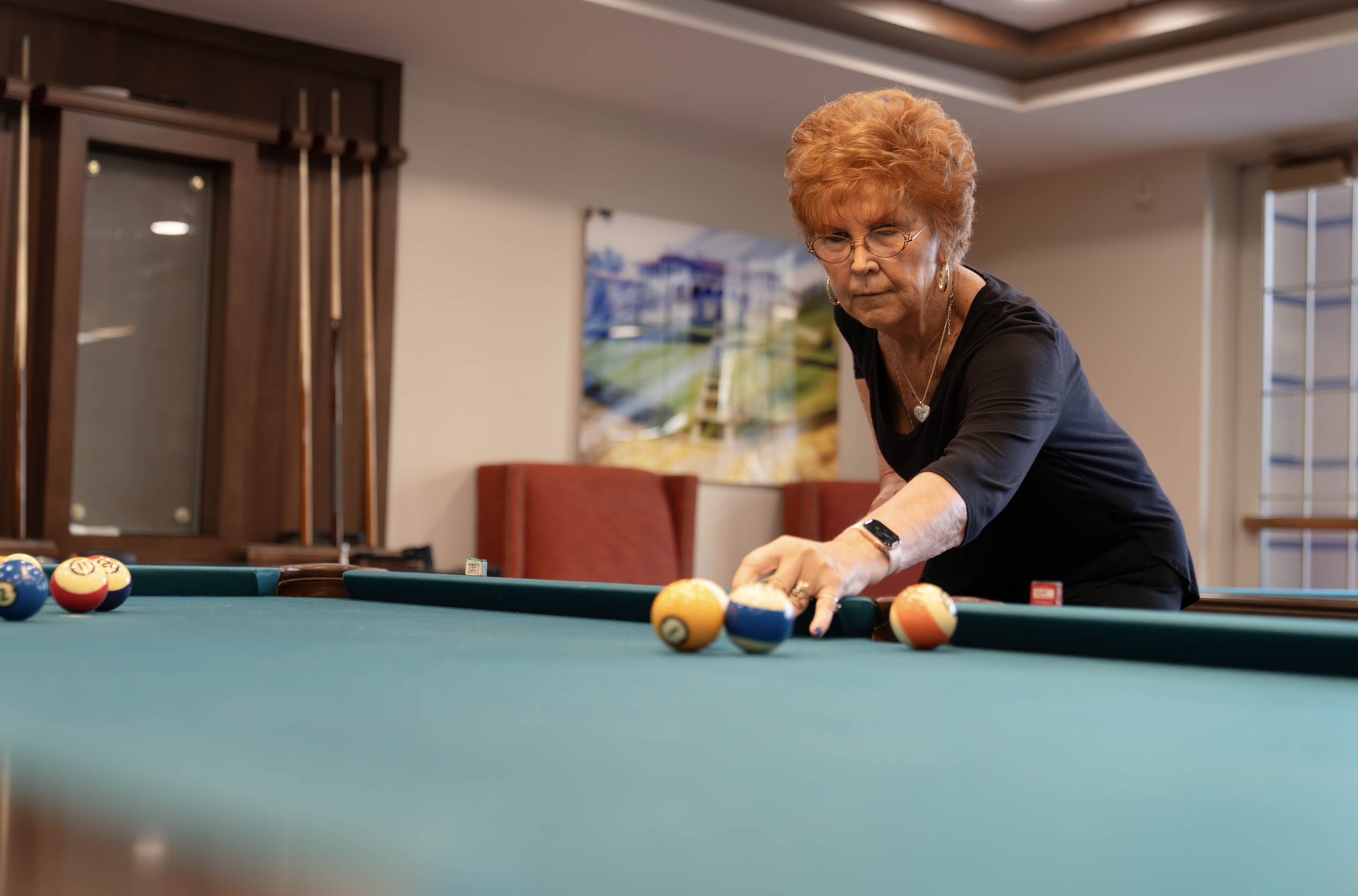 Woman playing billiards