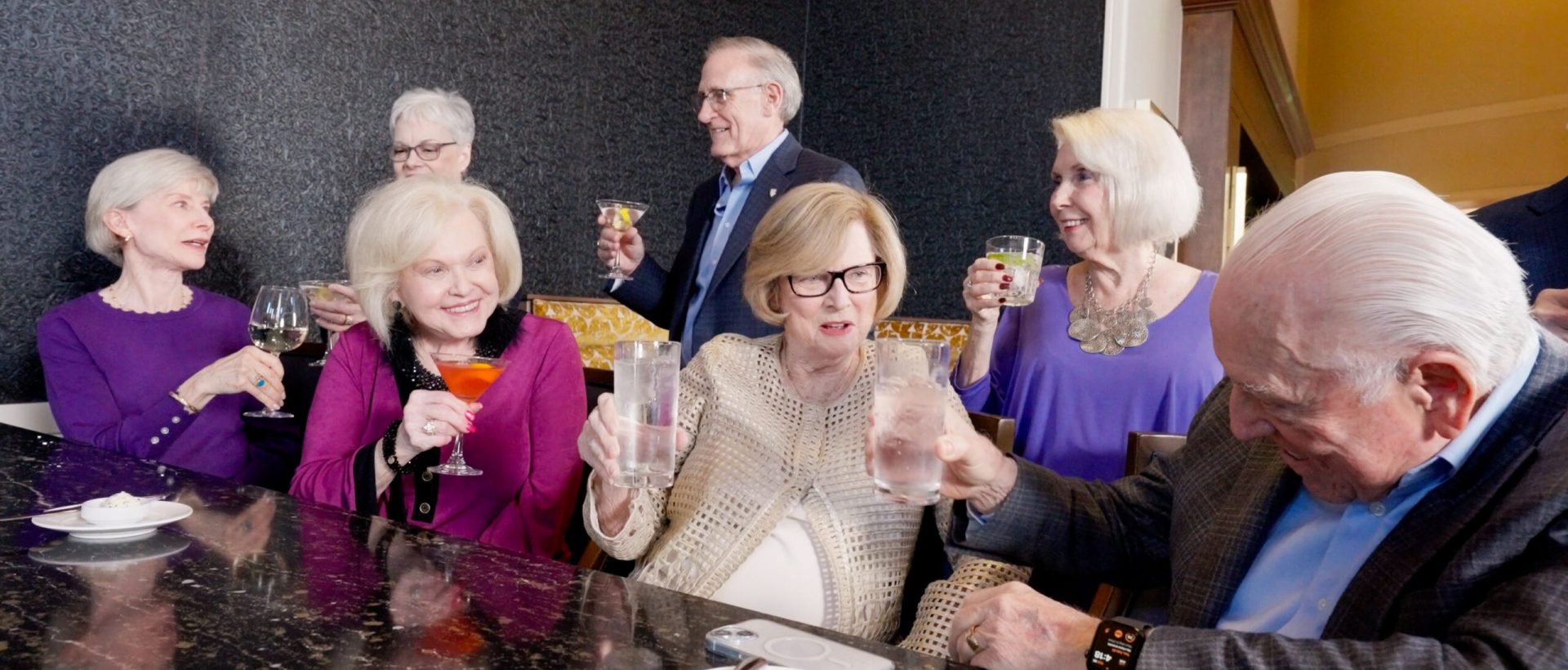 Lifestyle-Wide-shot-of-a-group-of-residents-at-bar-enjoying-drinks